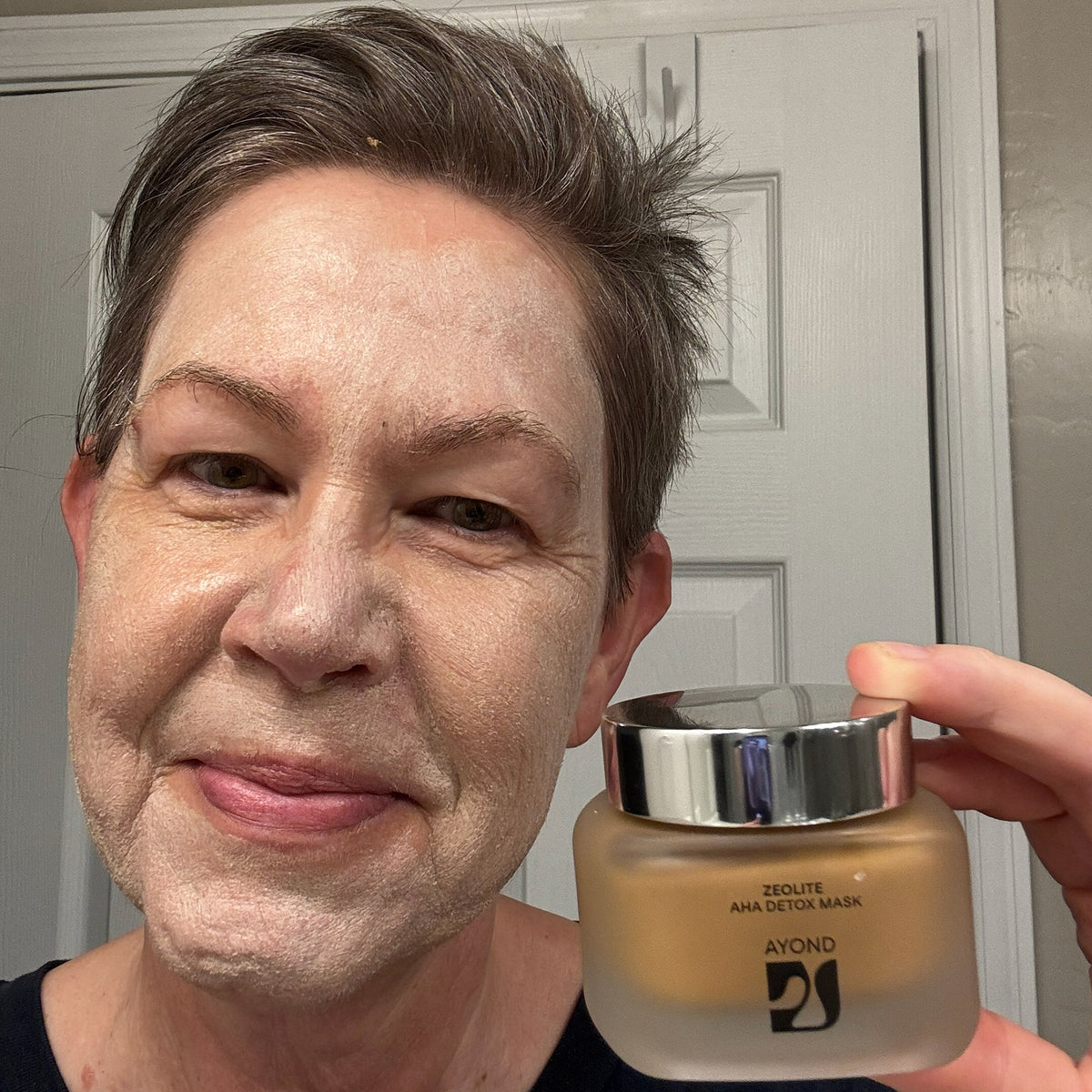 Customer smiling while wearing the Zeolite AHA Detox Mask