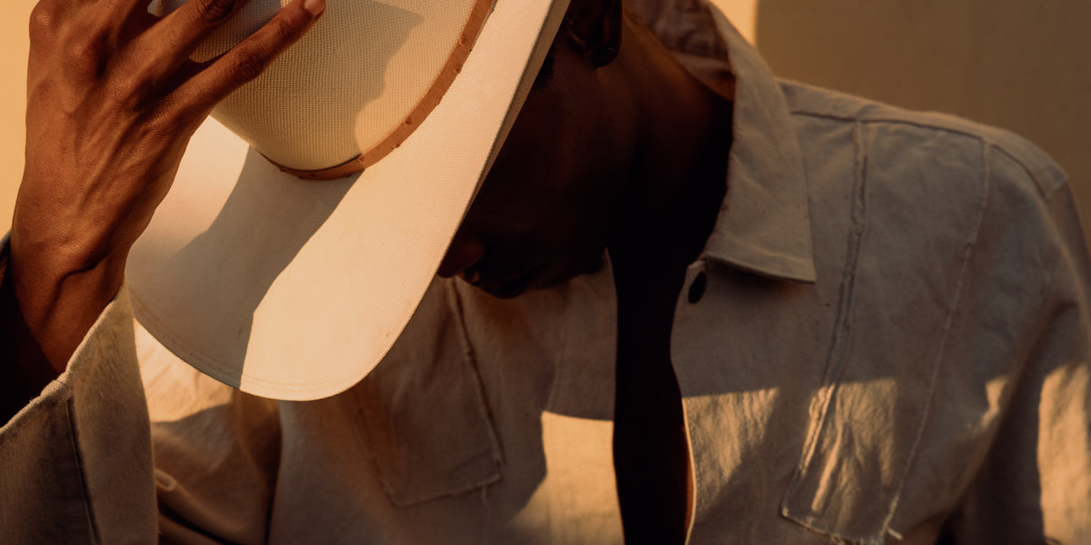 Man in a wide-brimmed hat in warm sunlight