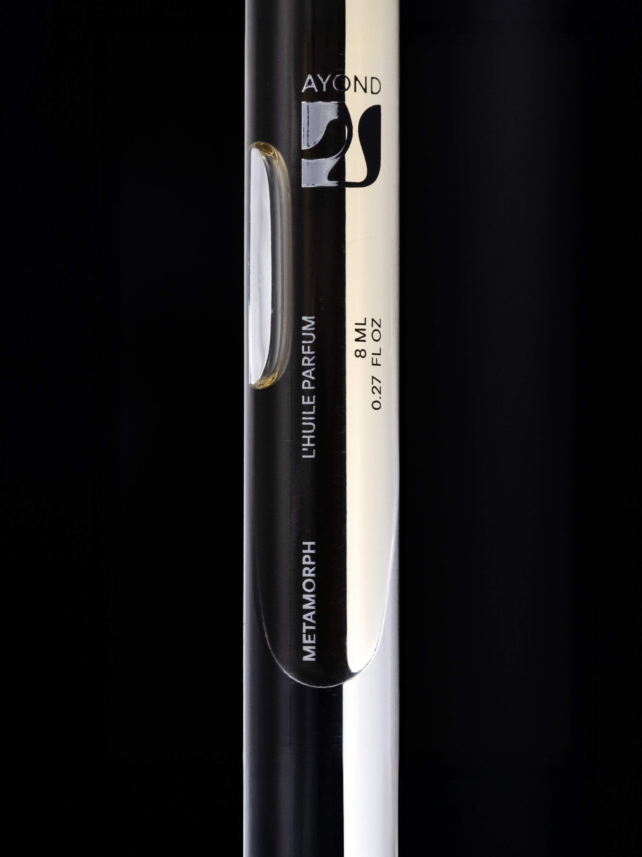 Metamorph Perfume Oil rollerball on a black background