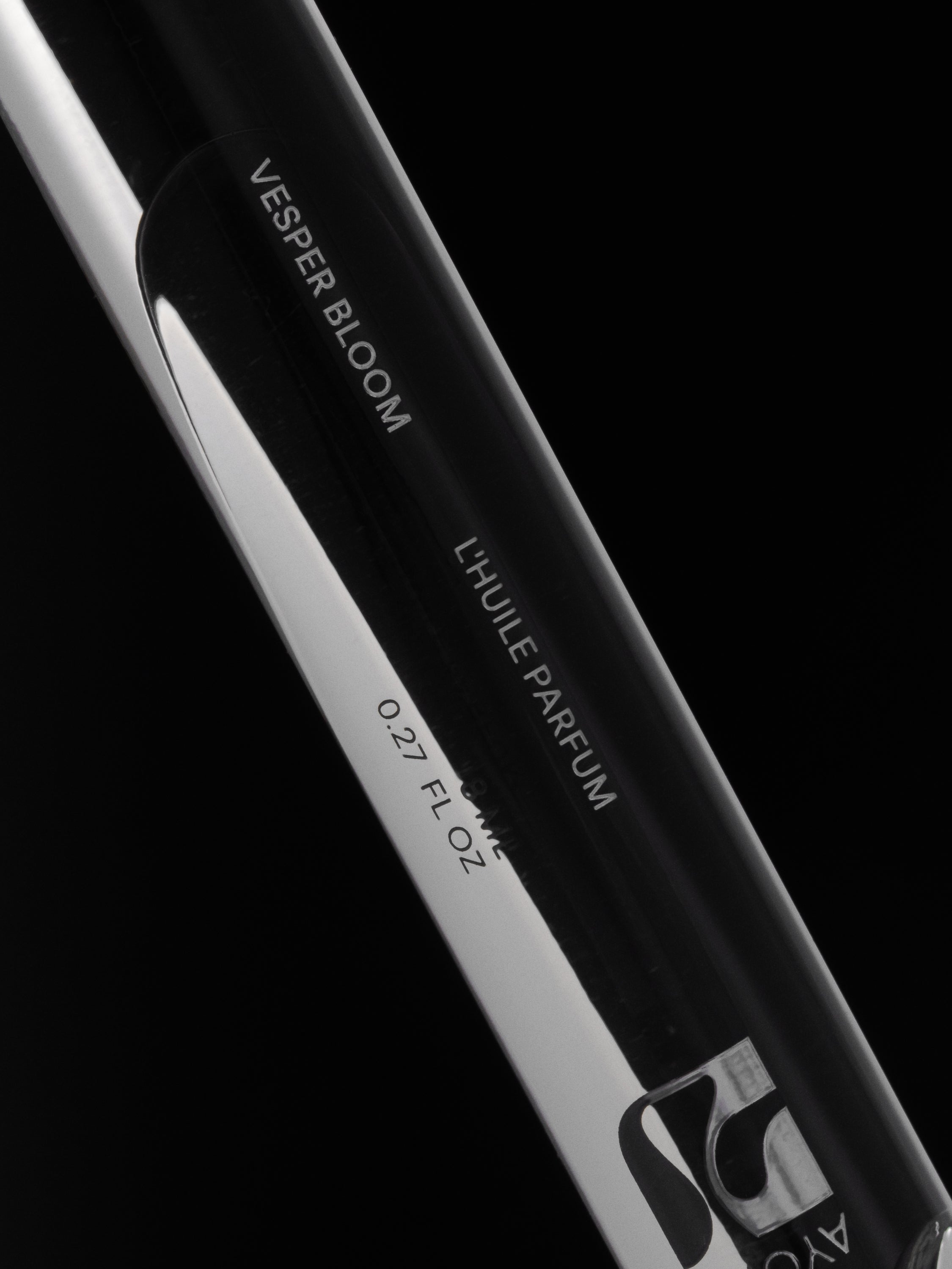Vesper Bloom Perfume Oil rollerball on a black background
