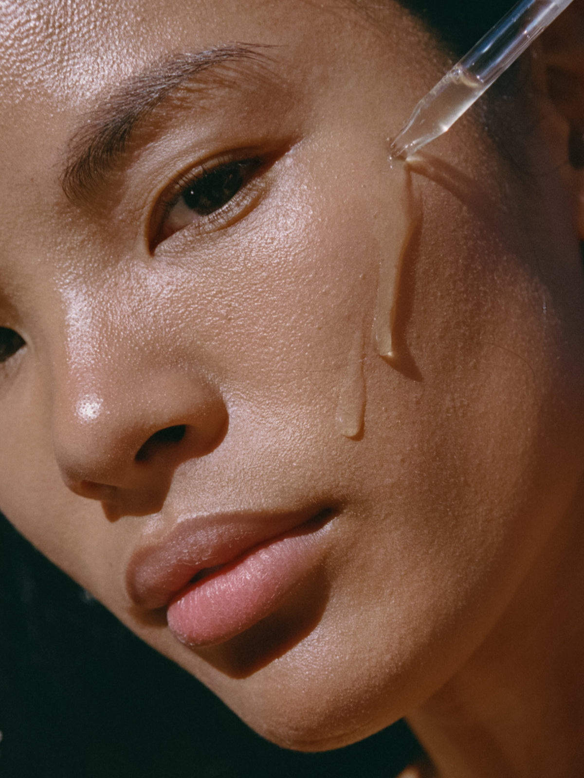 Woman applying Rock Rose Active Serum with a dropper