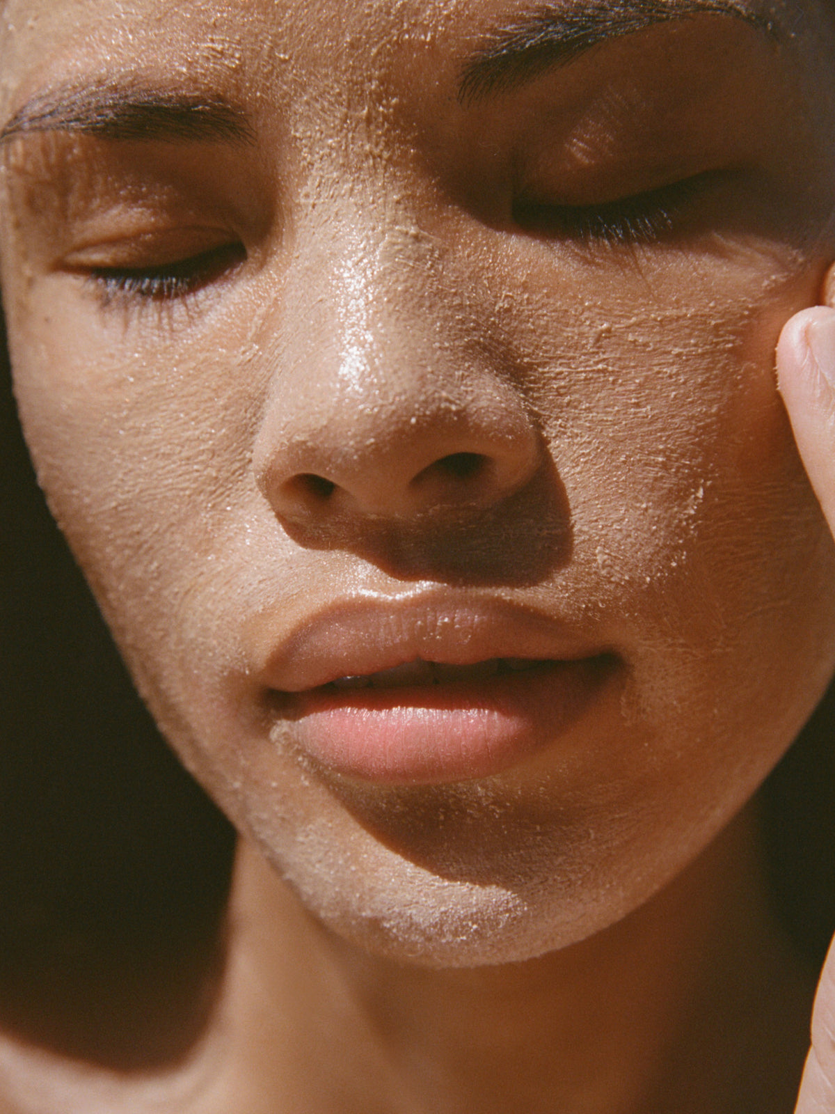 Woman with eyes closed wearing the Zeolite AHA Detox Mask