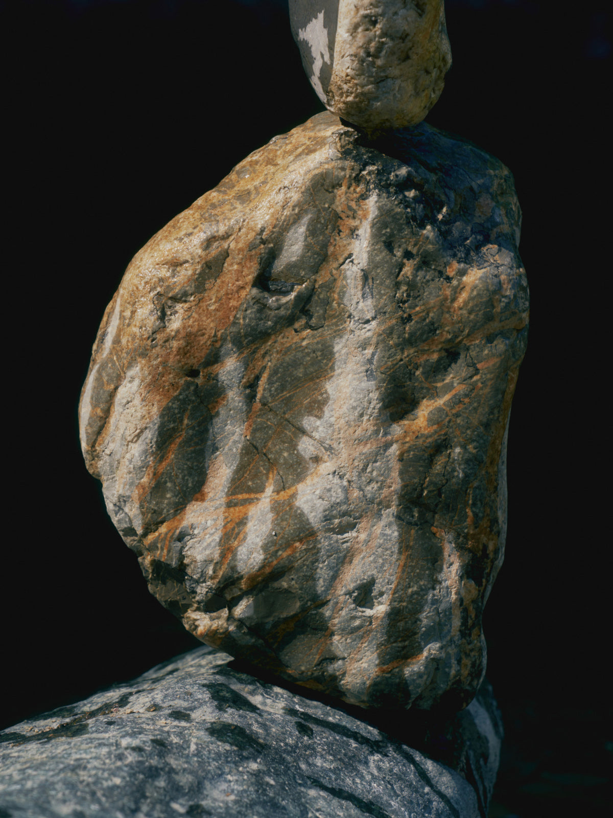 Balanced desert stones against a dark background